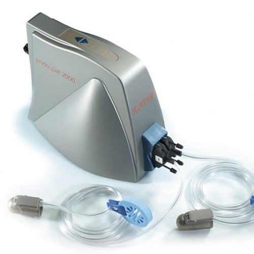 Silver Endopat machine with two clear, coiled up tubes attached to it against a white background.