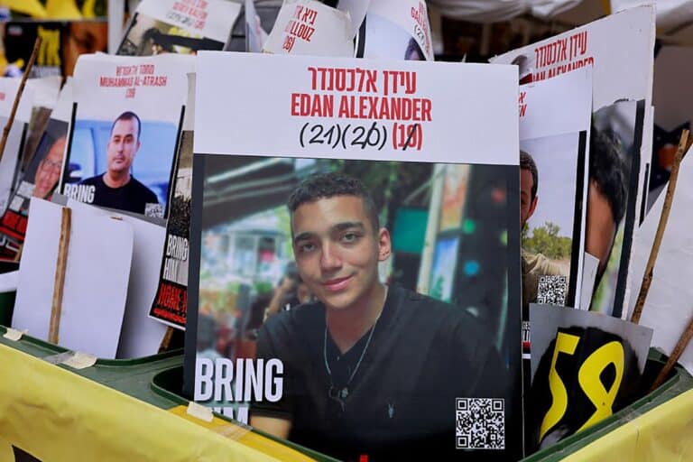 A sign showing the face of Israeli-US hostage Edan Alexander (C), who has been held by Hamas in Gaza since October 2023, is pictured among portraits of other Israelis held captive in Gaza at Hostages Square in Tel Aviv on May 12, 2025.