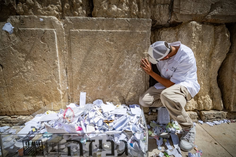 Workers remove handwritten notes placed between the ancient stones of the Western Wall, in Jerusalem on September 15, 2024, before the holiday of the Jewish New Year. Photo by Yonatan Sindel/Flash90
