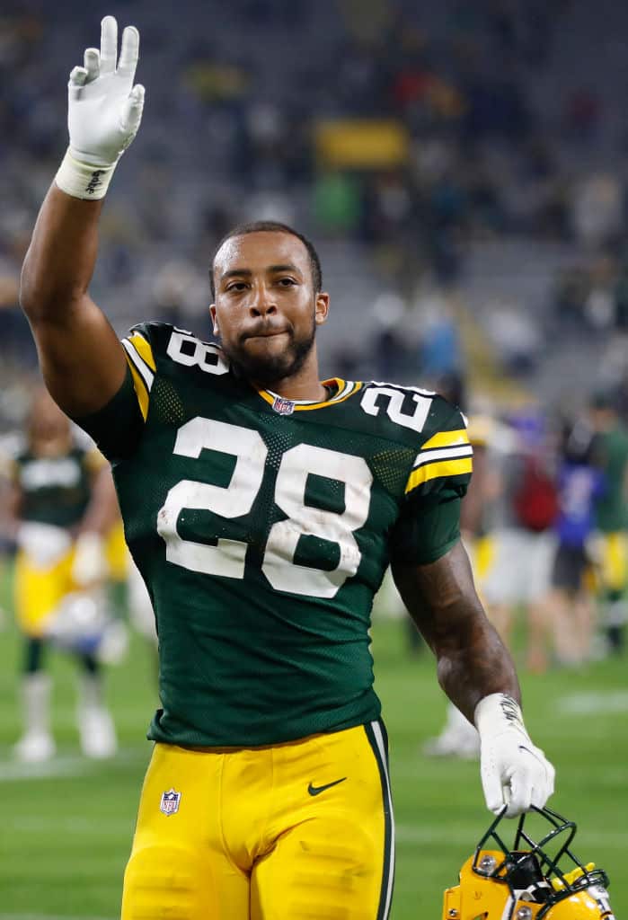 A.J. Dillon #28 of the Green Bay Packers reacts as he walks off the field following the team's win against the Detroit Lions during an NFL football game at Lambeau Field on September 20, 2021 in Green Bay, Wisconsin. (Photo by Wesley Hitt/Getty Images)