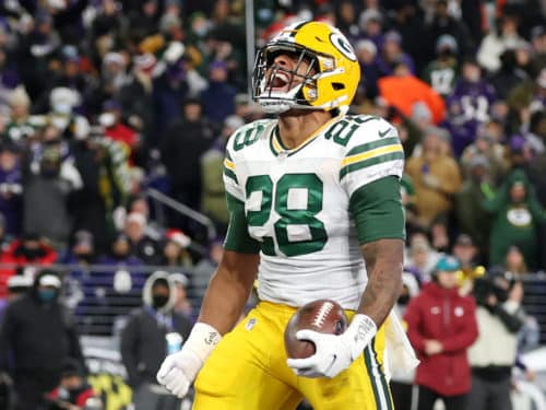 BALTIMORE, MARYLAND - DECEMBER 19: A.J. Dillon #28 of the Green Bay Packers reacts scoring on a rushing touchdown against the Baltimore Ravens in the second quarter at M&T Bank Stadium on December 19, 2021 in Baltimore, Maryland. (Photo by Rob Carr/Getty Images)