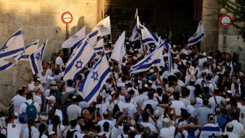 Israeli right-wing activists gather with Israeli national flags at the Damascus Gate of the old city of Jerusalem on June 5, 2024, during the Jerusalem Day flag march which commemorates the Israeli army's capture in the 1967 Arab-Israeli war of the city's eastern sector home to the Temple Mount. (Photo by Menahem KAHANA / AFP) (Photo by MENAHEM KAHANA/AFP via Getty Images)