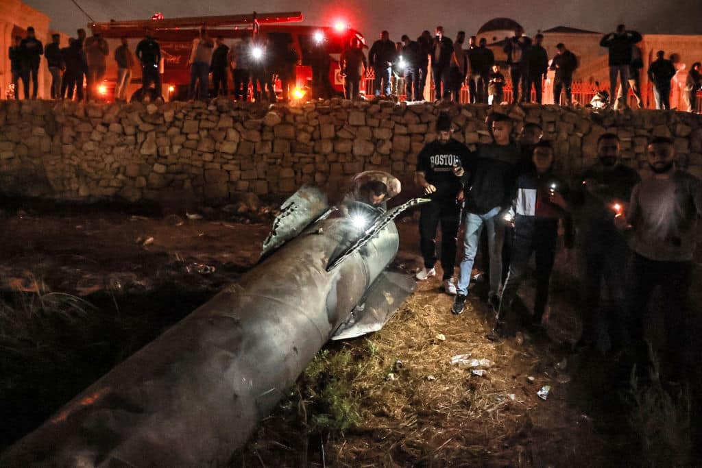 Palestinian youths inspect a fallen projectile after Iran launched a barrage of missiles at Israel in response to the killings of Lebanese Hezbollah leader Nasrallah and other Iran-backed militants, in Ramallah in the occupied West Bank on October 1, 2024. 