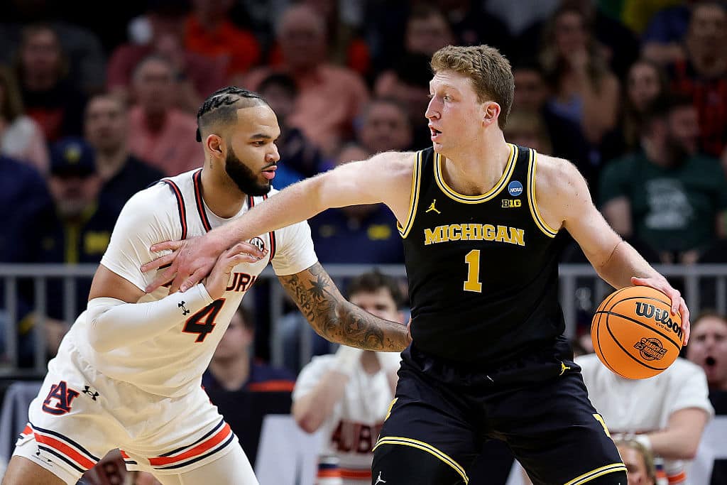 ATLANTA, GEORGIA - MARCH 28: Danny Wolf #1 of the Michigan Wolverines dribbles the ball against Johni Broome #4 of the Auburn Tigers during the first half in the South Regional Sweet Sixteen round of the NCAA Men's Basketball Tournament at State Farm Arena on March 28, 2025 in Atlanta, Georgia.  (Photo by Alex Slitz/Getty Images)