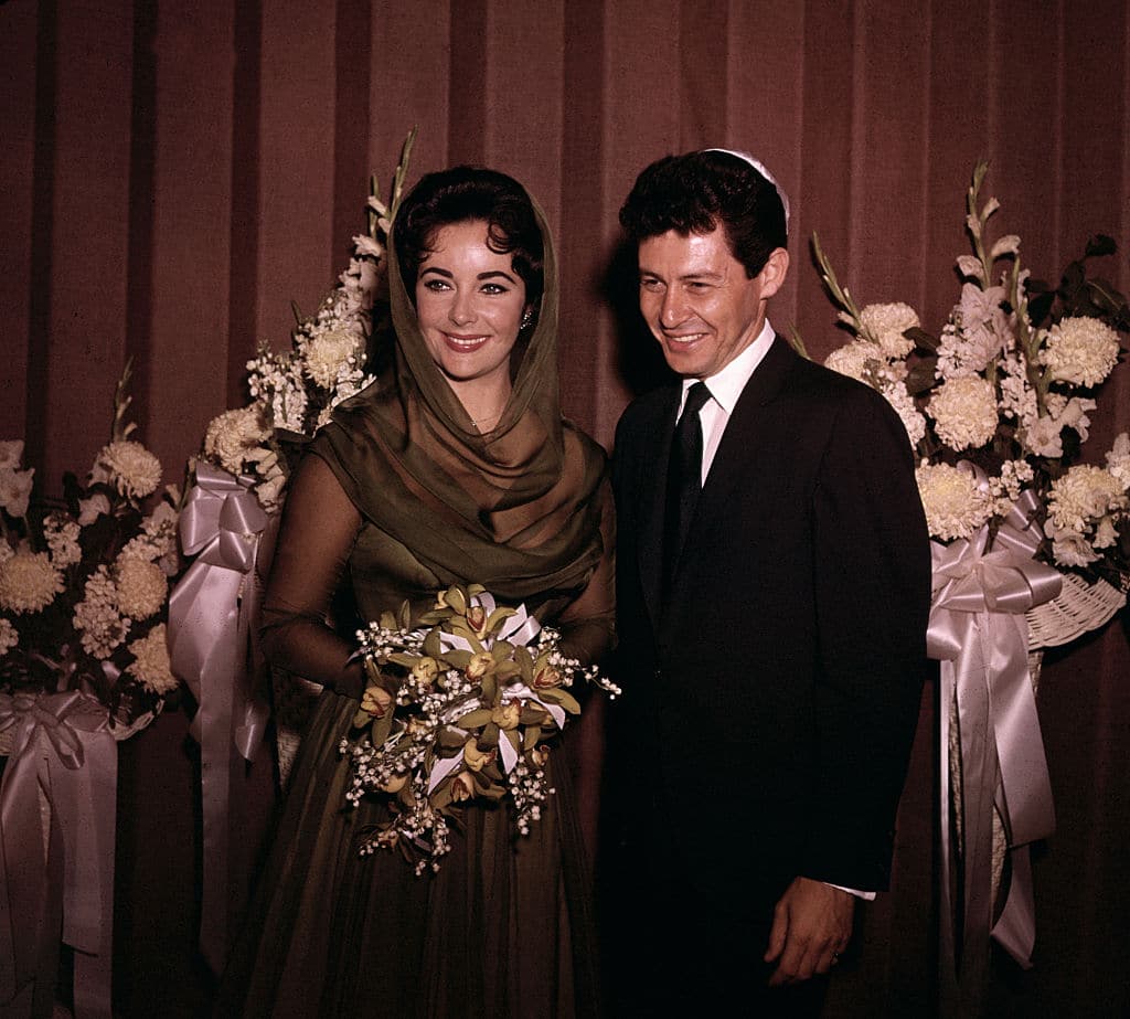 (Original Caption) 5/12/1959-Las Vegas, NV- Eddie Fisher and Elizabeth Taylor are shown after their wedding at Temple Beth Shalom. No pictures were allowed during the actual wedding ceremony.
