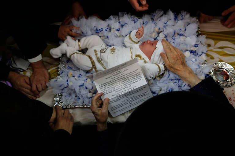 REHOVOT, Sept. 7, 2016 -- An ultra orthodox Jewish Rabbi of the Kretchnief Hasidic sect blesses a thirty-day-old infant during the "Pidyon Haben" ceremony at a synagogue in Rehovot, 30 km south of Tel Aviv, Isreal, Sept. 6, 2016. The Pidyon Haben, or redemption of the first-born son, is a mitzvah in Judaism whereby a Jewish firstborn son is redeemed by use of silver coins from his birth-state of sanctity. (Xinhua/Gil Cohen Magen via Getty Images)