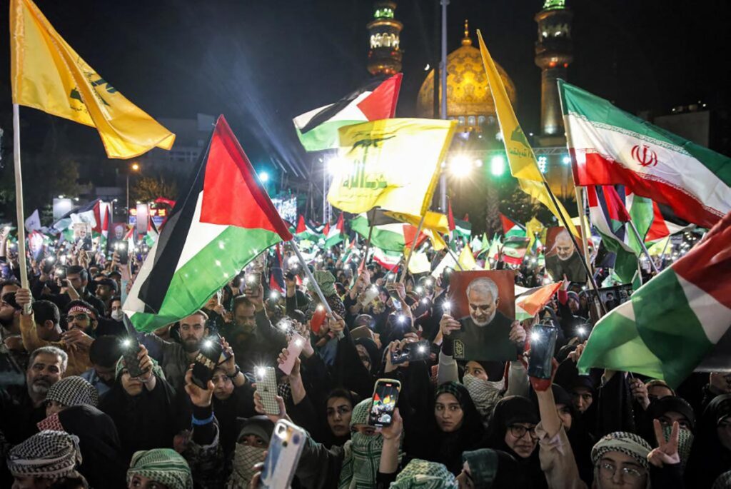 Demonstrators gather with Iranian and Palestinian flags and the yellow flags of the Lebanese Shiite movement Hezbollah during a protest in Tehran in support of Palestinians in the Gaza Strip on October 20, 2023 amid the war between Israel and Hamas.