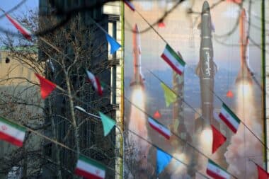 A view of a banner hung on a building reading in Persian and Hebrew 'We are stronger and more motivated than ever. Are you ready for 2 million displaced people?' with pictures of Iranian missiles as tensions between Iran and Israel continue to escalate in Palestine Square of the capital Tehran, Iran.