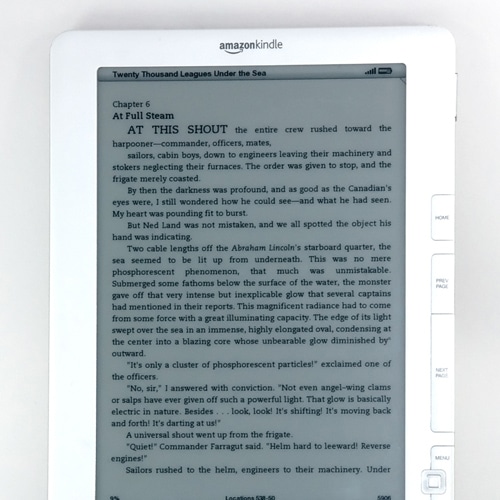 A Kindle displaying text from Twenty Thousand Leagues Under the Sea by Jules Verne. The screen shows chapter 6, At Full Steam, with a description of the crew readying the ship amid changes in weather.