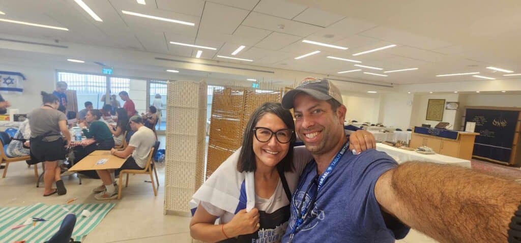 Group leader Aaron Herman with Revital Ben-Tzur who paused a launch of a new tech firm to get food to soldiers and runs a distribution center.  
