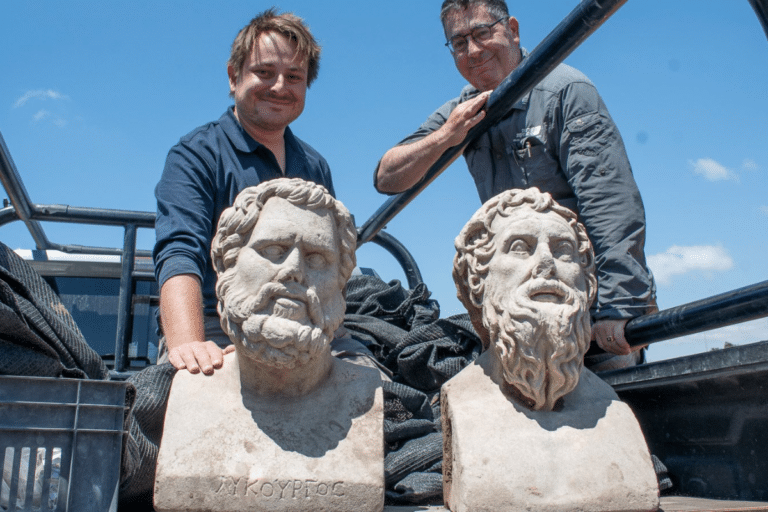 Archaeologists Eliran Oren and Michael Sorotskin with the Roman statues discovered in northern Israel.