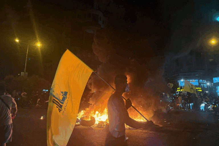 Supporters of Lebanon's Hezbollah terrorist group block the streets with burning tires as they rally in cars and motorbikes to protest the government's endorsement of a plan to disarm it, in Beirut's southern suburbs early on August 8, 2025