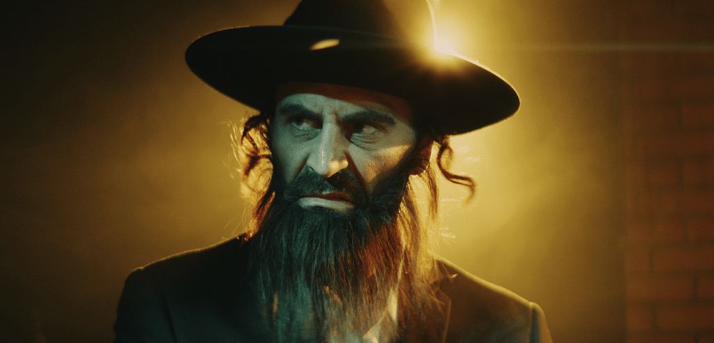 Amnon Carmi as the "Rebbe"