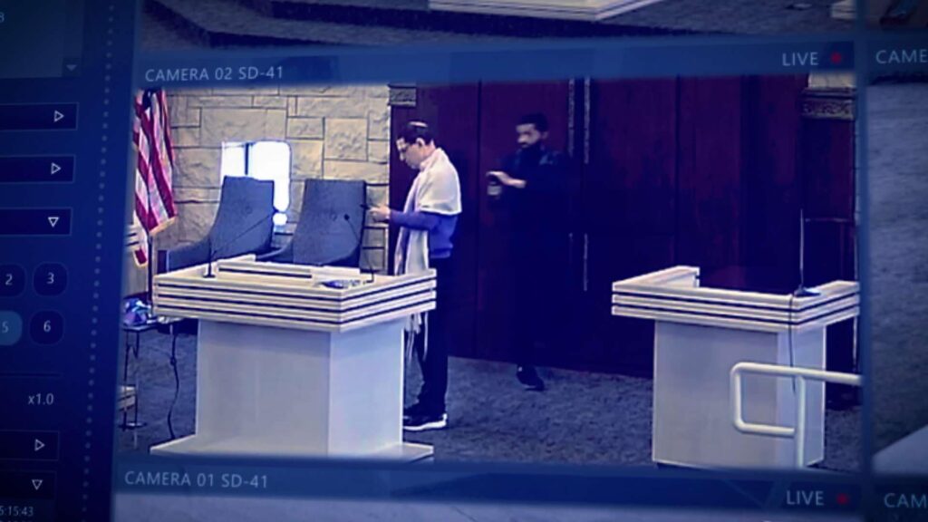 A still from the film showing Malik Akram on the bima with Rabbi Cytron-Walker, captures by cameras streaming it on Zoom.