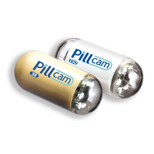 Two pill cam tablets sitting next to each other on a white background. The left pill is gold and the right pill is white, both have the words Pill Cam written on them.
