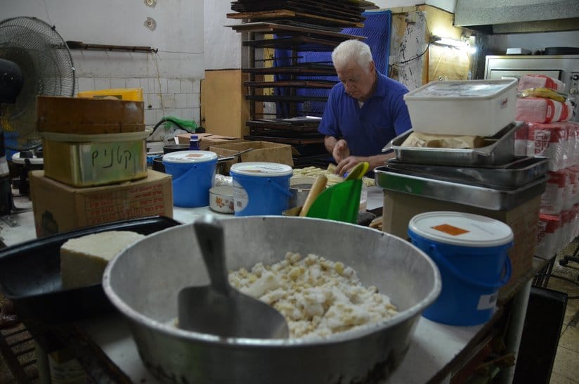 Yehuda Yaakov prepares meringue kisses at the Konditoria Albert, a Greek bakery at Levinsky Market./Erez Kaganovitz